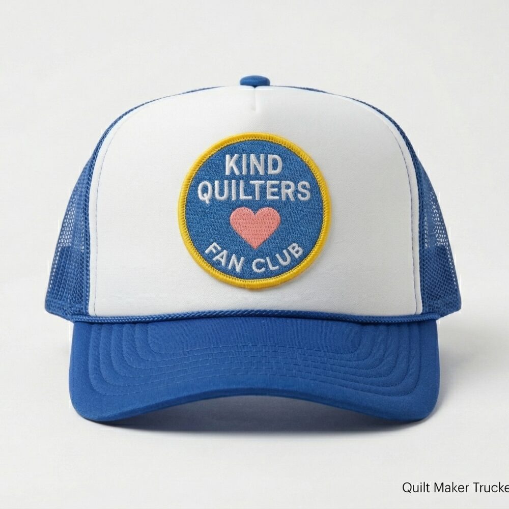 Royal blue and white trucker hat with embroidered &ldquo;Kind Quilters Fan Club&rdquo; patch on front with a pink heart